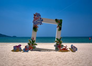 a picture frame sitting on top of a sandy beach