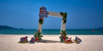 a picture frame sitting on top of a sandy beach