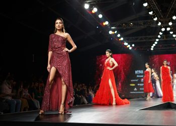 woman wearing maroon one-shoulder slit-side dress
