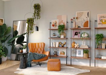 brown and black armchair beside white wooden shelf